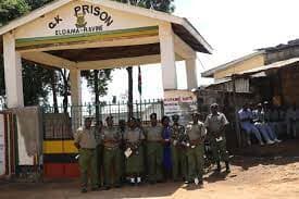 Four inmates at Eldama Ravine Prison sit KCPE