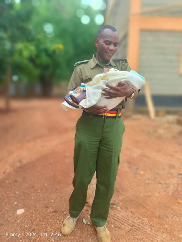 Photo of police nursing child as mother sits KCSE goes viral