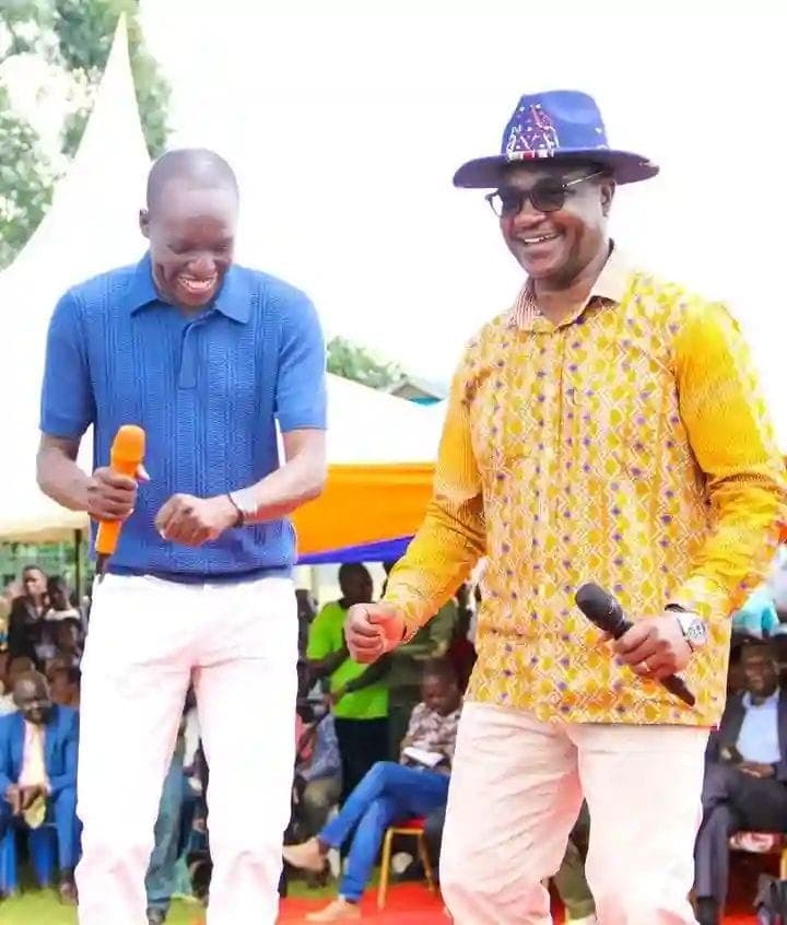 CS for Education Julius Ogamba (right) in light moments with Kisii County Governor Simba Atati at Entanda Primary School. Photo: Enock Okong'o