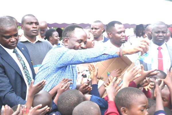 Trans Nzoia Governor George Natembeya distributes milk to ECDE learners during the launch of free milk programme at Township Primary on Tuesday April 2