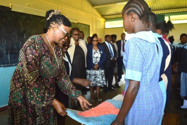 Chief Justice Martha Koome admires a mat crafted by one of the girls