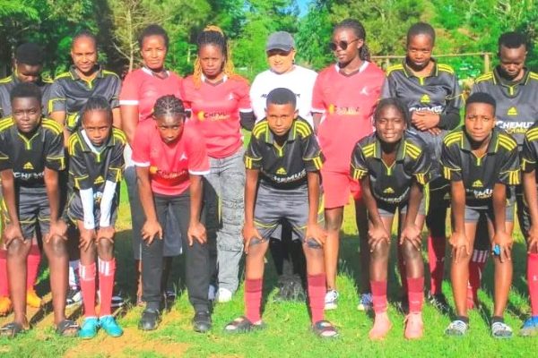 Espodec Starlets Patron Chemutai Kurgat shares a light moment with former Harambee Stars head coach Jacob ‘Ghost Mulee during a recent football tournament at Kipkenyo Grounds Uasin Gishu County
