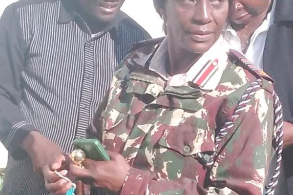 Gucha DCD Esther Kungu Educationn Director David Oyoko right and Ibrahim Nyamosi during the Opening of the examination container at her County security offices
