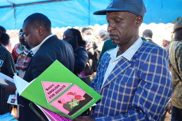 Man reads a book during during Nairobi County International Literacy Day celebrations.Photo by Obegi Malack