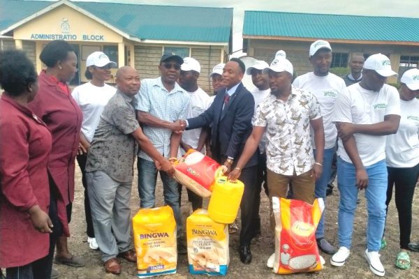 The Chairman of Kamwana Foundation Samuel Maithya handsover donating of food items on Friday to some School teachers of Mukengesya Day School in Matungulu Sub county.Photo by Gastone Valusi