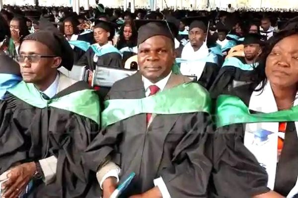 Cardinal Otunga Mosocho National School Principal Dr Ezekiel Okeyo middle savouring good moments after being awarded a PhD degree at Kisii University