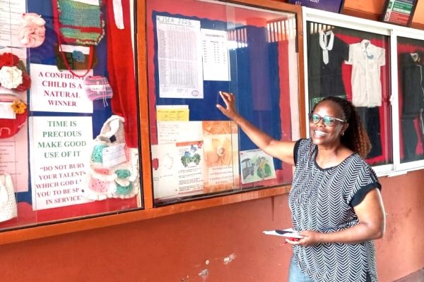 Esther Mihingu st. Anthonys school kindergarten primary and junior school kiambu headteacher going through the performance list of KJSEA results