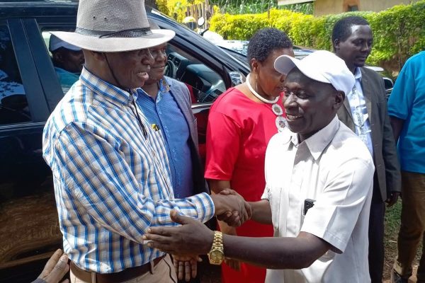 Hesbon Otieno KNUT Deputy Secretary General warmly greets former Bomet KNUT Assistant Executive Paul Sang during a church fundraiser at AGUC Chekeilek Mogogosiek Ward Konoin Sub county