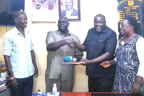 Outgoing Oriwo Boys High School principal Henry Airo hands over office to incoming principal Tom Amadi during a leadership transition at the Homa Bay County institution