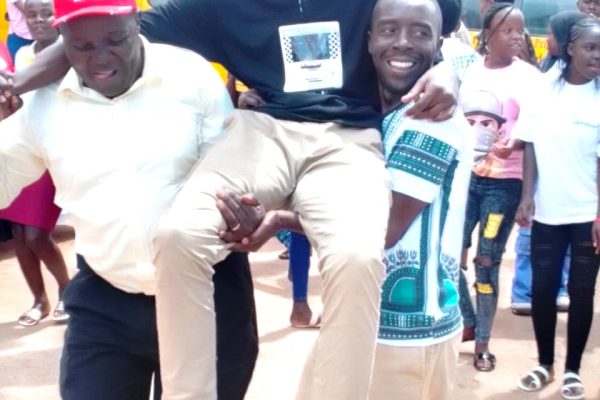 Parents of Hurricane Academy in Kisii County celebrate with Gabriel Nyatwanga in spectacles who scored 64 points