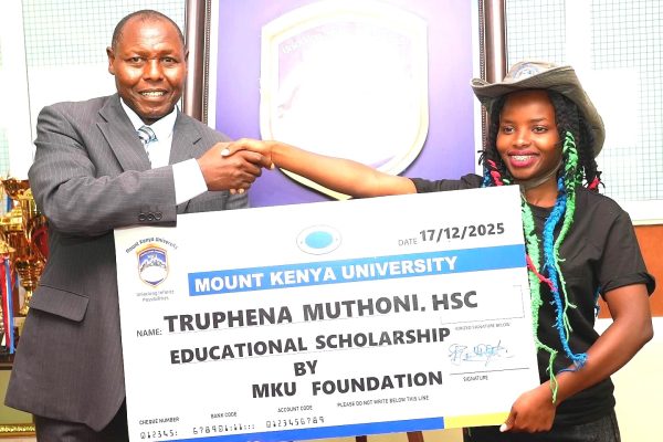 Prof Peter Wanderi MKU Principal Corporate Communications and Alumni Relations awards a full scholarship to environmentalist Truphena Muthoni at the university in Thika