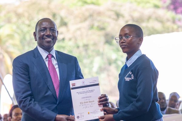 President William Ruto presents an award to Lydia Mogusu during the Gold Award Presentation ceremony under the President’s Award Programme Kenya (PA-K)-Photo|Courtesy