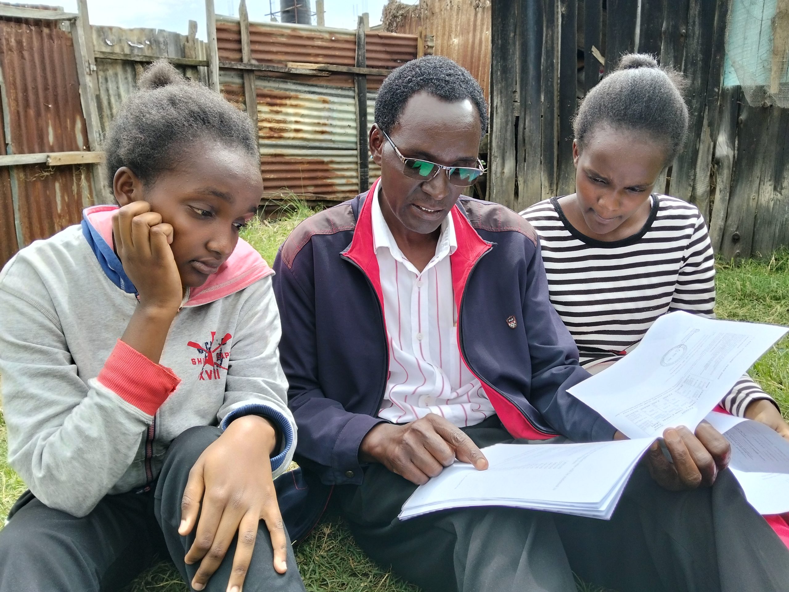 Twin sisters with their father