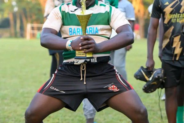 Kakamega School rugby player pose with a trophy