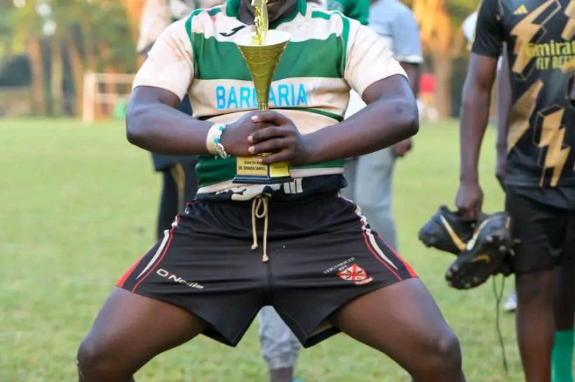 Kakamega School rugby player pose with a trophy