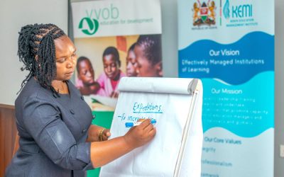 A school leaders in the third cohort of the Effective School Leadership for Junior Schools ESL4JS training taking notes during group discussions during an in person session . 1