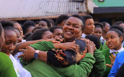 Kisii County Woman Representative Dorice Donya Aburi embraces a students