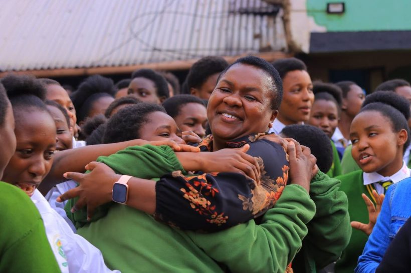 Kisii County Woman Representative Dorice Donya Aburi embraces a students