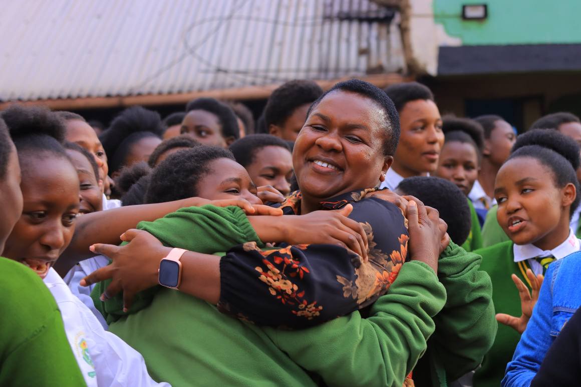 Kisii County Woman Representative Dorice Donya Aburi embraces a students