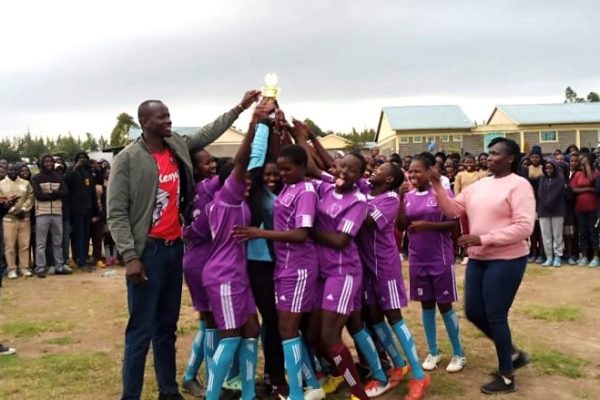 Olashapani Girls secondary school basketball team celebrate their victory with their principal Glory Nkatha during the Narok South sub county refined