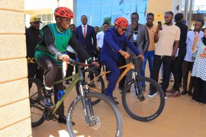PLO Lumumba in green reflector leads in commissioning the cycling for peace event