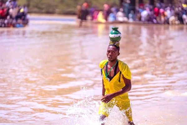 Participants plunge into a muddy river during the Argungu Fishing Festival