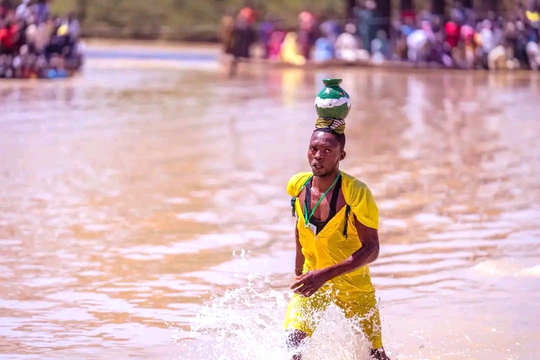Participants plunge into a muddy river during the Argungu Fishing Festival