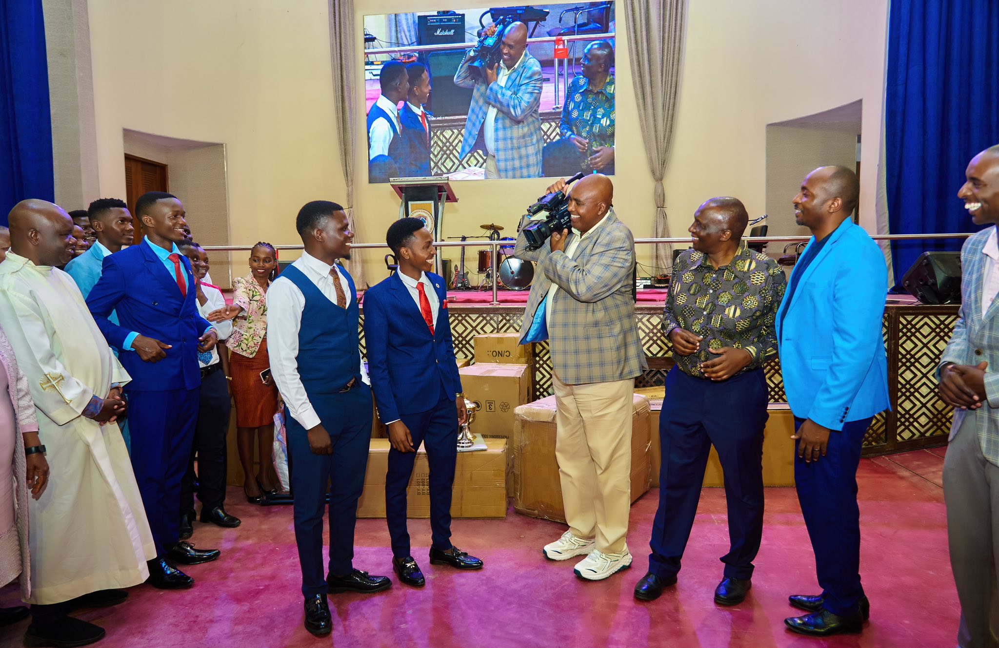 Varsity to help cash-strained students complete their studies 2 Prof Simon Gicharu hands over equipment to MKU's interdenominational students on Sunday.