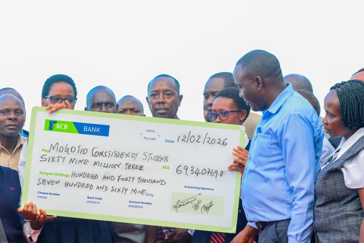 MP Reuben Kiborek issuing a cheque.