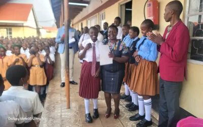 Mitua Girls senior school Principal Angelina Kosgei recognizing students who excelled in terms one co curriculum activities.