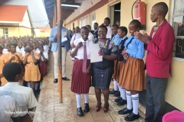 Mitua Girls senior school Principal Angelina Kosgei recognizing students who excelled in terms one co curriculum activities.