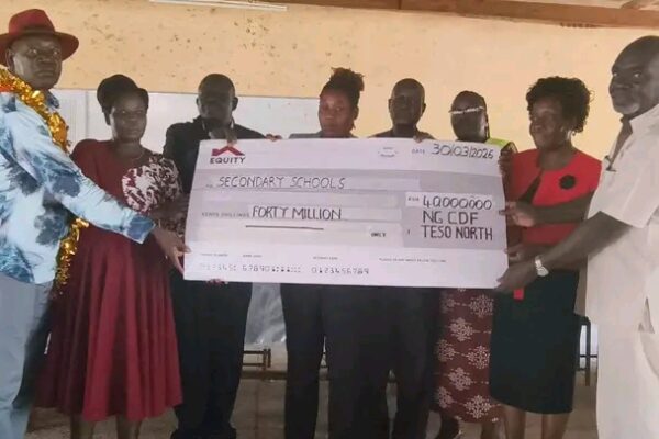 Teso North MP Oku Kaunya and other officials displaying dummy cheque