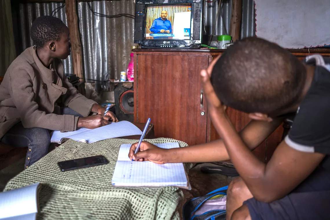 Learners doing their home assignments in a single room