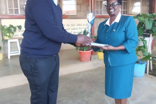 AIC Philemon Chelagat Girls Principal Joan Zaddy receiving the winning trophy during the Rift Valley Drama Festivals held at Menengai High School in Nakuru. Photo Courtesy