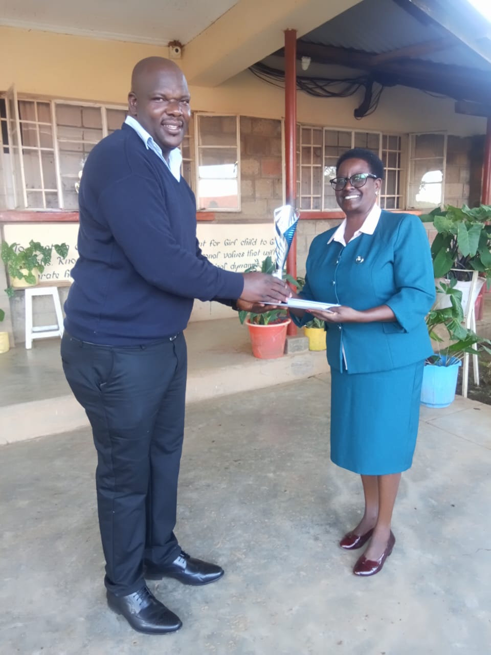 AIC Philemon Chelagat Girls Principal Joan Zaddy receiving the winning trophy during the Rift Valley Drama Festivals held at Menengai High School in Nakuru. Photo Courtesy