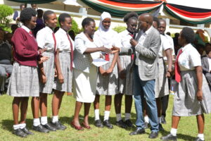 Baringo Central NG-CDF disburses Ksh 73Million to boost learning for needy learners 2 Baringo Central Mp Joshua Kandie awarding cheque to AIC Philemon Chelagat Girls.