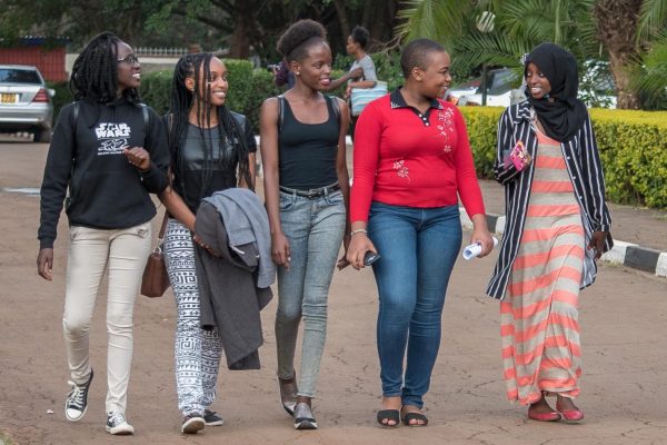 Campus students having a chat. The writer is calling upon parents to fund their daughters in Universities rather than leaving them for the World.
