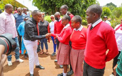 Gatundu North MP Elijah Njoroge Kururia with students during bursary issuance to over 4000 day schools