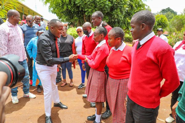 Gatundu North MP Elijah Njoroge Kururia with students during bursary issuance to over 4000 day schools
