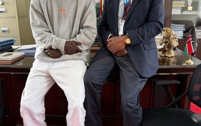 Daystar University Vice Chancellor Prof Laban Ayiro meets student-athlete Patrick Odongo at his office at Daystar University on Friday to discuss his academic and rugby progress.