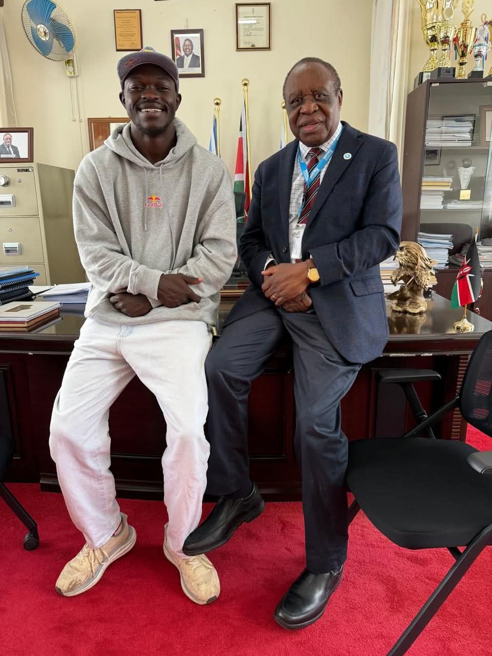 Daystar University Vice Chancellor Prof Laban Ayiro meets student-athlete Patrick Odongo at his office at Daystar University on Friday to discuss his academic and rugby progress.