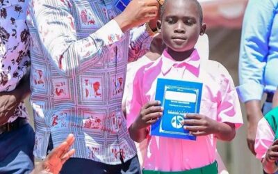 Businessman Joseph Waswa during issuing school uniforms and books