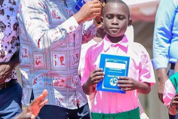 Businessman Joseph Waswa during issuing school uniforms and books