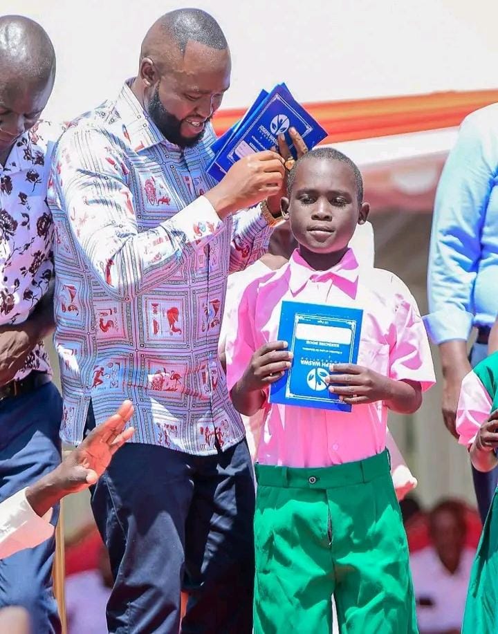 Businessman Joseph Waswa during issuing school uniforms and books