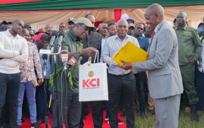Narok Governor Patrick ole Ntutu (left) hands over bus documents to Rongena Senior School Principal Paul Soi (right) during the official commissioning of the Sh10.5 million school bus funded by the Narok county government.