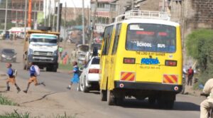 Students dangerously cross Magadi road the road has got no pedestrian ways .Photo Obegi Malack