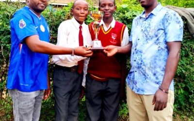Carlos Mumo and Charles Mwendwa of Malivani AIC display their trophy with patrons James Wambua and Solomon Musyoki after KSEF Eastern regional competitions at Matuu Memorial Girls High School.