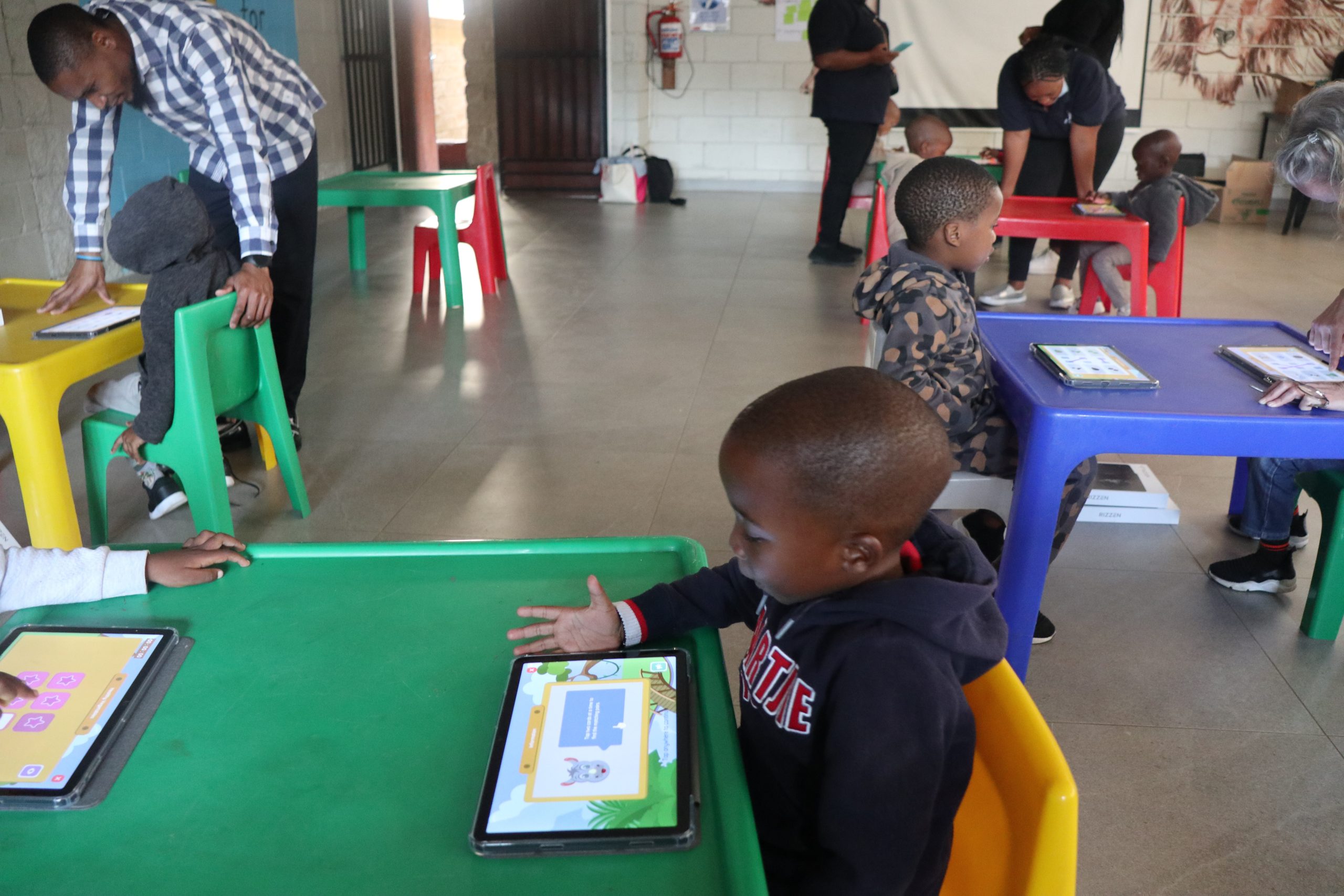A child with a digital garget in ECDE class