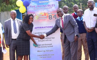 Vihiga Boys Senior Principal Robert Masiolo (r) poses for a photo with teachers and BoM members during the 2026 KCSE target
