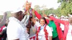 Early Childhood Development Education Director Mdm Martha Odundo (at the centre)awards a trophy to Rift Valley Region officials for emerging overall winners in this year's KPJSSA-SPORTS Championship held in Maseno School. Photo by Peter Amos